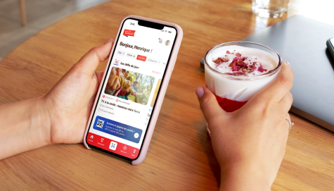 Main tenant un téléphone et un dessert